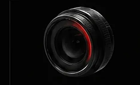 High-contrast optical sensor with a red illuminated ring.